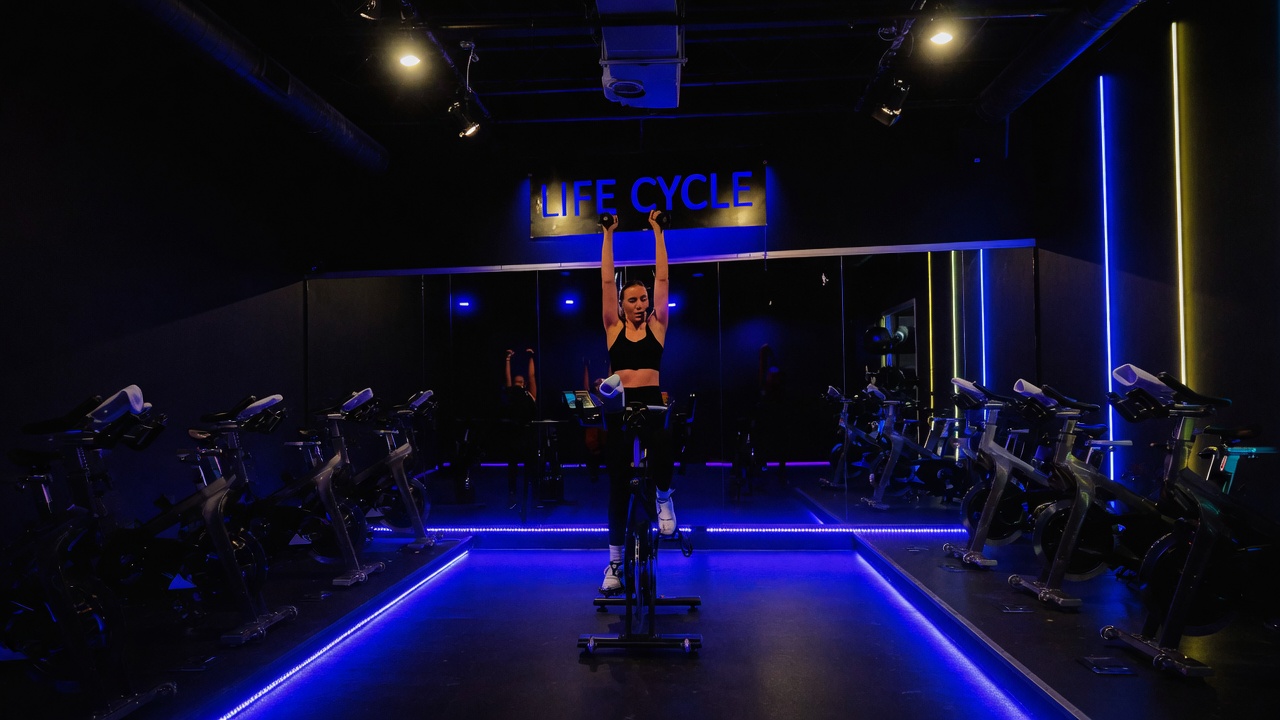 Life Cycle podium bike under neon and LED floor lights